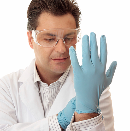 A man looking at his glove-encased hand