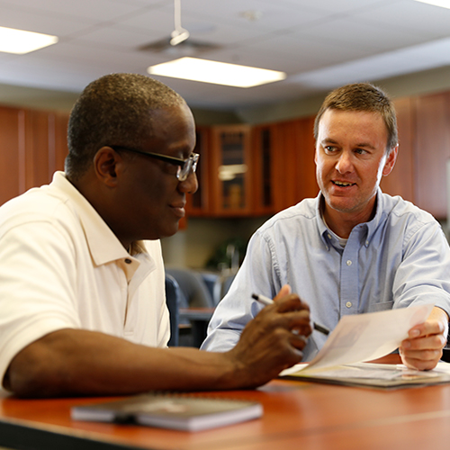 Two men reviewing documents