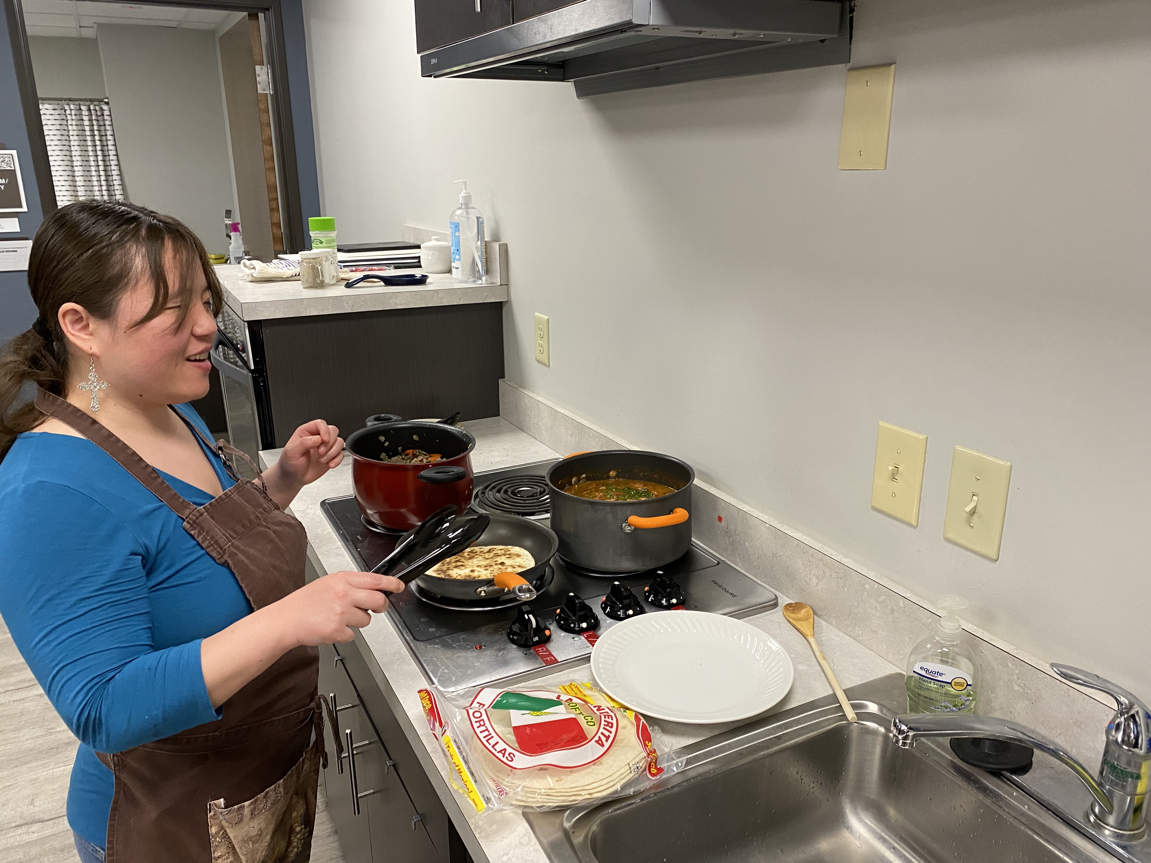 Kathryn Hurd smiles in a candid photo while preparing her Mexican-inspired meal. 